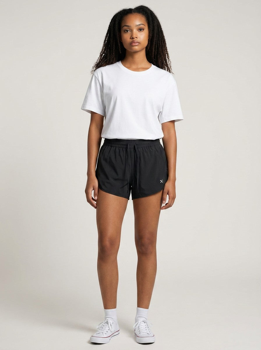 Model wearing EHG SmartWellness black athletic Bermuda shorts with a drawstring waist and white t-shirt
