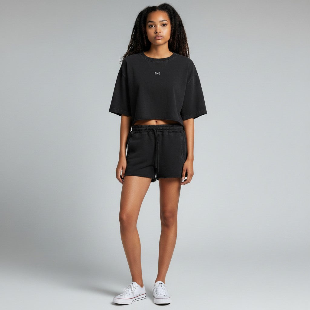 Model wearing EHG SmartWellness black snow-washed cotton crop top with dropped shoulders and raw-edge hem.
