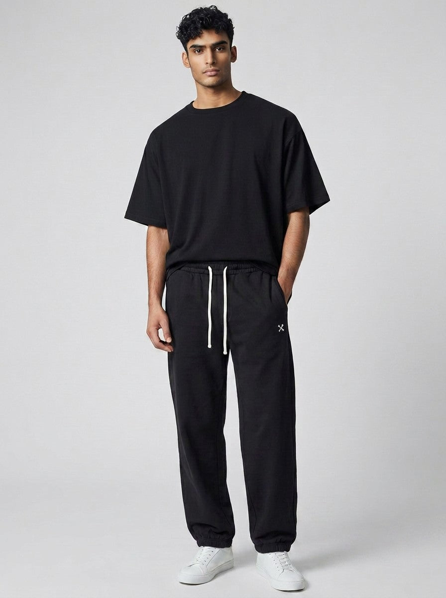 Model wearing EHG SmartWellness black heavyweight cotton sweatpants with a drawstring waist and relaxed fit.
