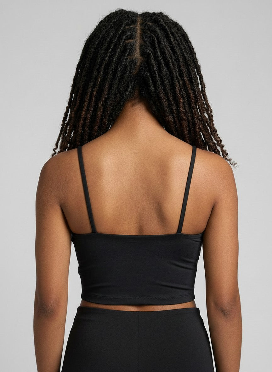 Back view of EHG SmartWellness black spaghetti strap yoga sports bra on a model with dreadlocks