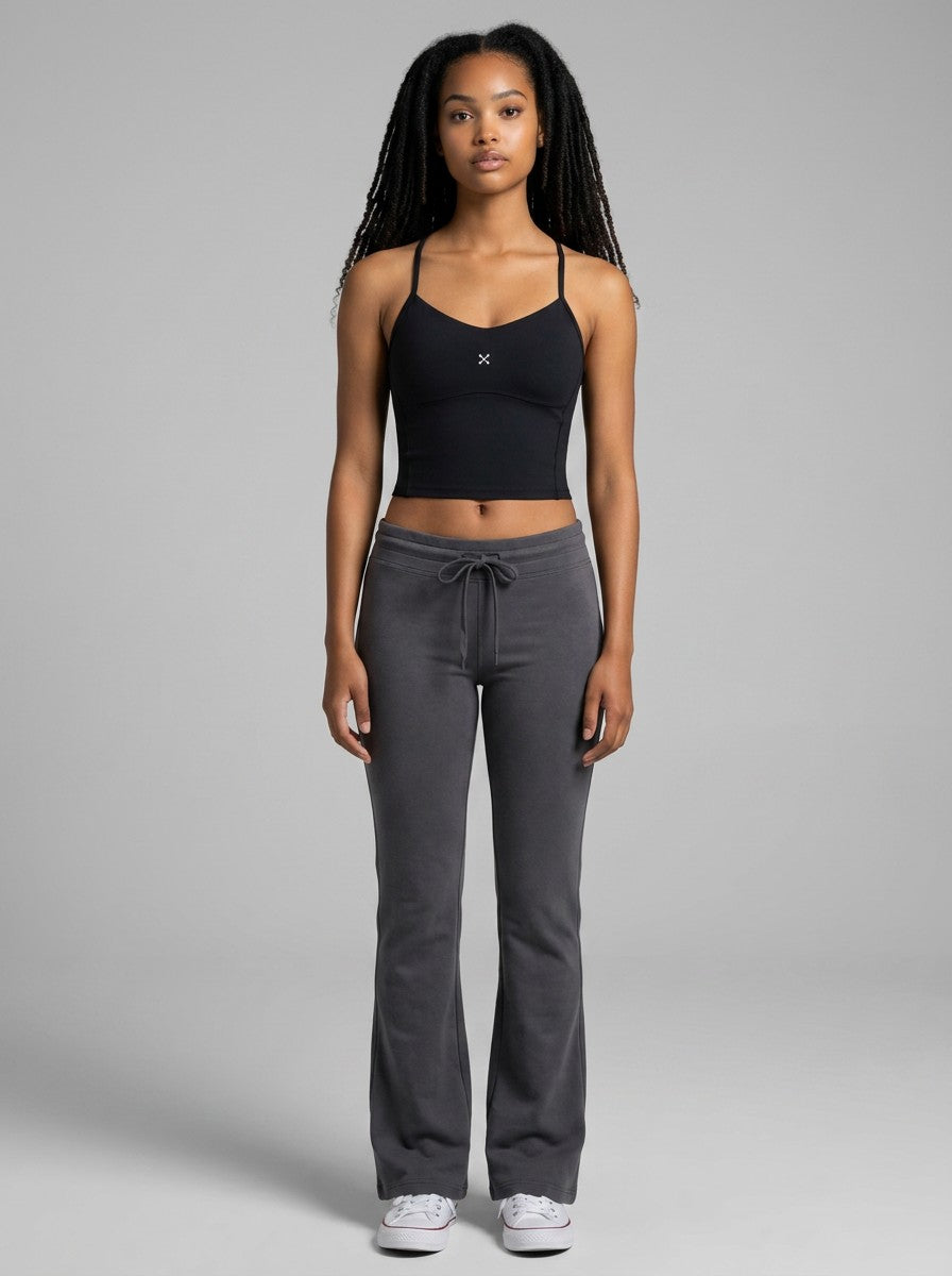 EHG SmartWellness black yoga sports bra crop top worn by a model with grey flared sweatpants and white sneakers
