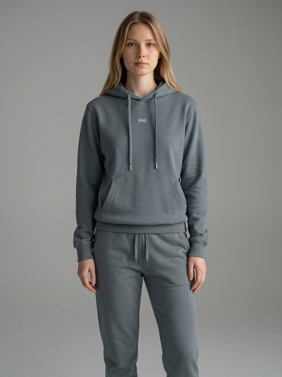 Model wearing an EHG SmartWellness blue cotton hoodie with a relaxed fit, drop shoulders, and front kangaroo pocket.