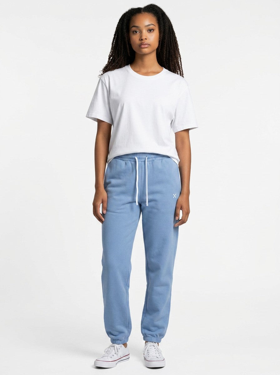 A model wearing EHG SmartWellness Essential Sweatpants in blue with a drawstring waist and white t-shirt.