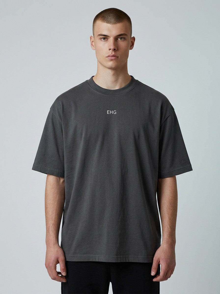 A model wearing an EHG SmartWellness heavyweight charcoal grey 100% cotton unisex t-shirt with a round neck.