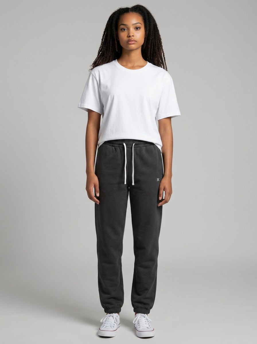 Model wearing EHG SmartWellness Essential Sweatpants in charcoal grey with a white drawstring and relaxed fit.