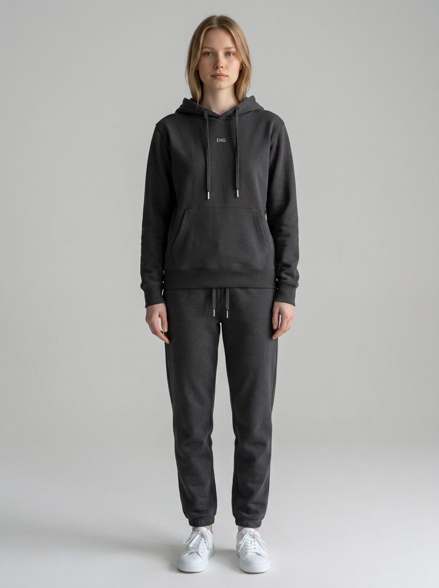 Model wearing EHG SmartWellness dark grey cotton hoodie with matching sweatpants and white sneakers.