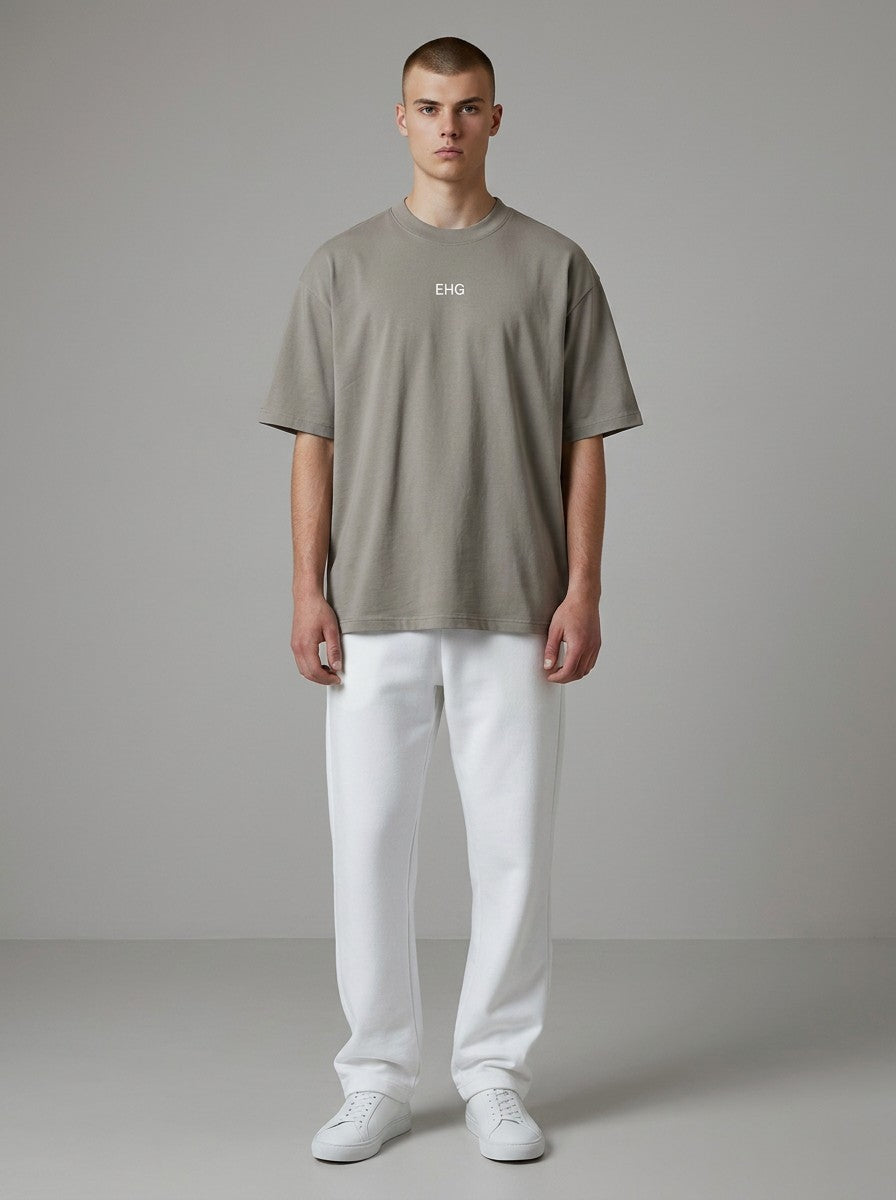 Model wearing an EHG SmartWellness heavyweight earth-tone cotton t-shirt with a round neck and white sweatpants.