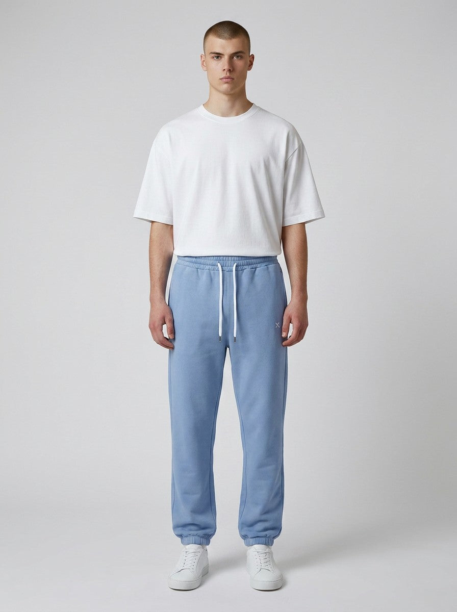 Model wearing EHG SmartWellness Essential Sweatpants in light blue with a drawstring waist and cuffed ankles.
