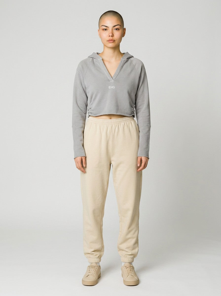 EHG SmartWellness grey cropped hoodie with raw edges and drop shoulders worn by a model with beige joggers