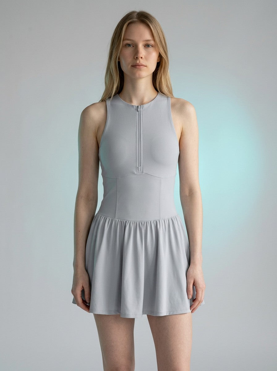 Model wearing EHG SmartWellness light grey sleeveless ruched full-zip athletic dress with a flattering fit.