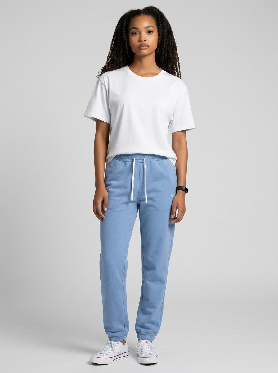 Model wearing EHG SmartWellness light blue heavyweight cotton sweatpants with a drawstring waist and white t-shirt