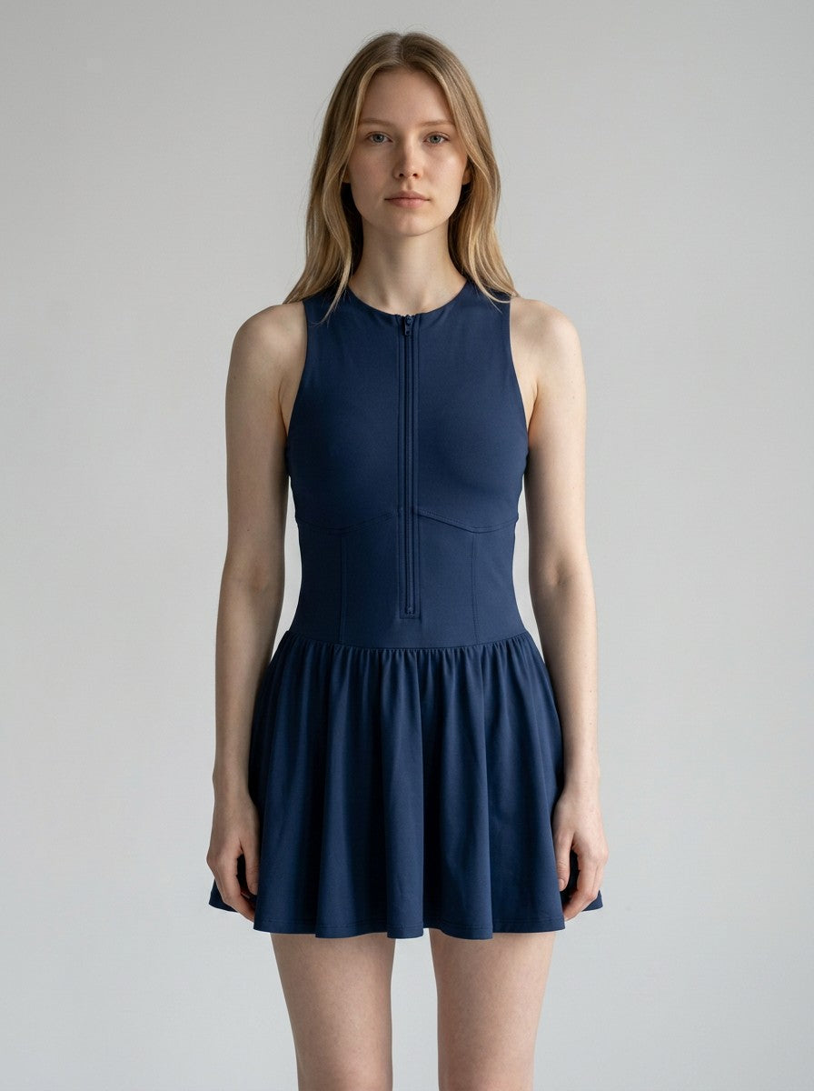 Model wearing a navy blue EHG SmartWellness sleeveless ruched full-zip dress with a round neck and flared skirt.