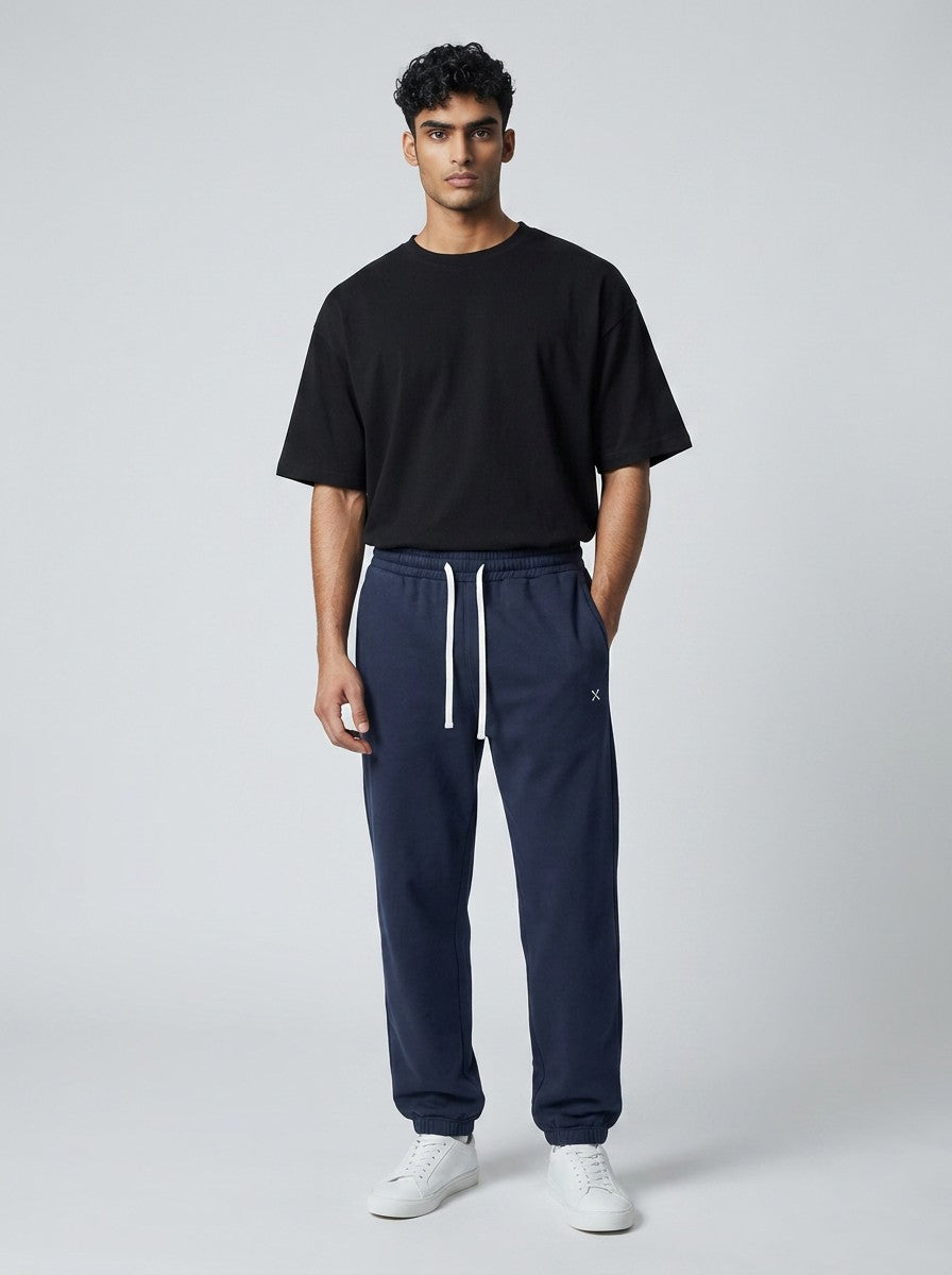 A model wearing EHG SmartWellness navy blue heavyweight cotton sweatpants with a drawstring waist and relaxed fit.