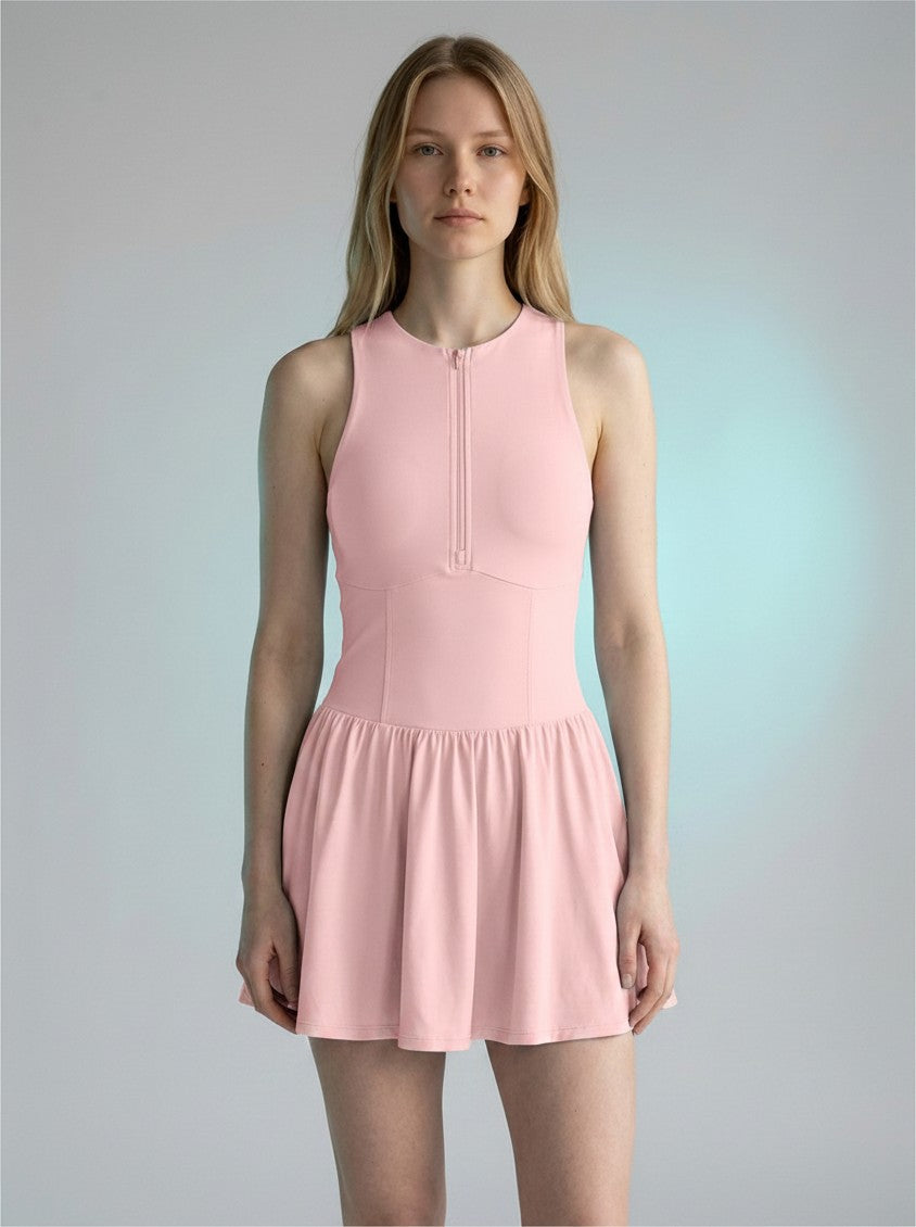 Model wearing a light pink EHG SmartWellness sleeveless ruched full-zip athletic dress with a round neck.