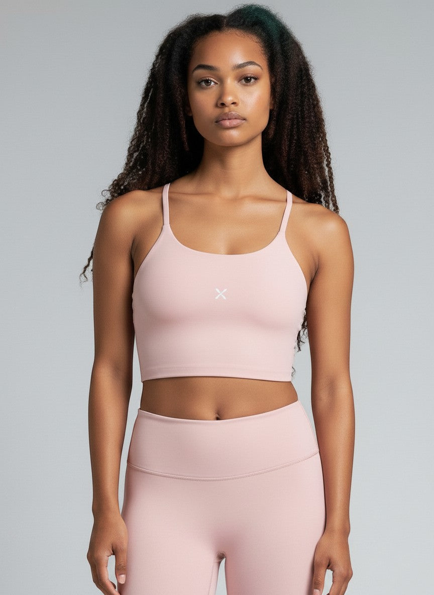 EHG SmartWellness light pink spaghetti strap yoga sports bra in a buttery-soft nylon-spandex blend on a model.
