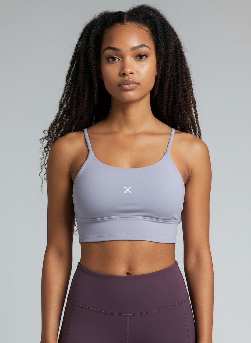 A model wearing an EHG SmartWellness light purple spaghetti strap yoga sports bra with a cropped bodycon fit.