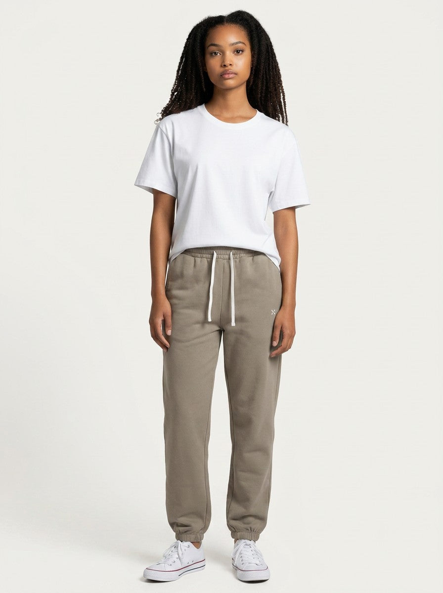 Model wearing EHG SmartWellness Essential Sweatpants in taupe with a white drawstring and matching white t-shirt.