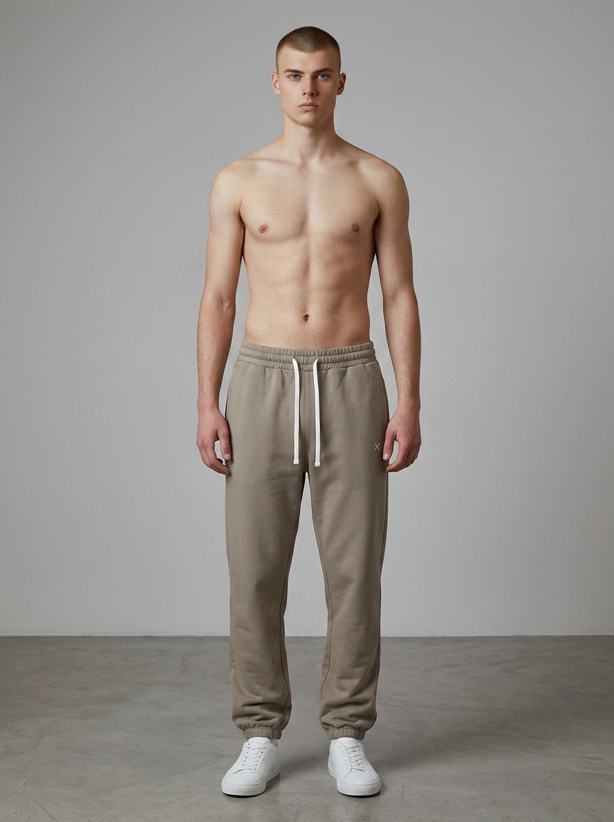 A model wearing EHG SmartWellness Essential Sweatpants in a neutral taupe colour with a drawstring waist.