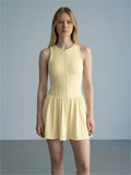 Model wearing a pale yellow EHG SmartWellness sleeveless ruched full-zip dress with a flattering fit.