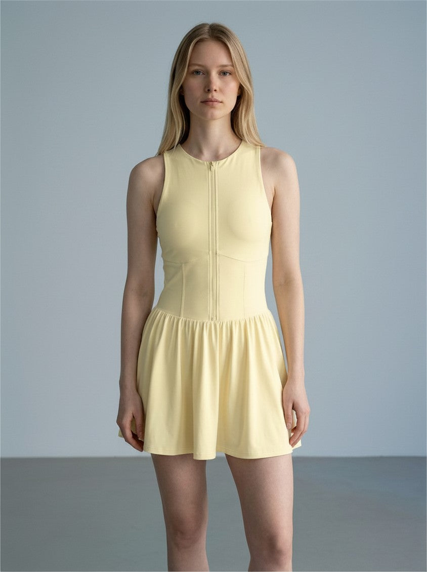 Model wearing a pale yellow EHG SmartWellness sleeveless ruched full-zip dress with a flattering fit.